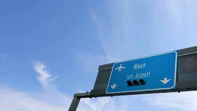 airplane flying over maun airport signboard