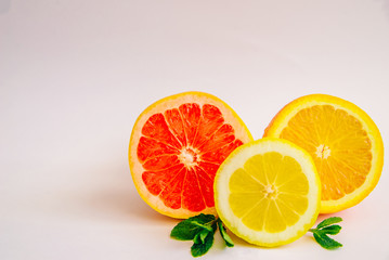 Fototapeta na wymiar Grapefruit, lemon and orange on a white background. Place for text