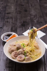 Indonesian Meatball Bakso Noodle with sweet soy sauce and chilli sauce sprinkle with green onion - 198023836