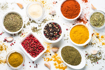 Various spices in a bowls on white.