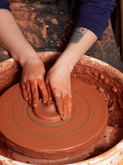 production process of pottery. Forming the clay cover of the kettle on the potter's wheel.