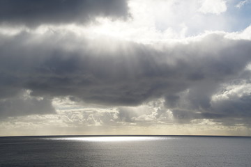 sun over the ocean and clouds