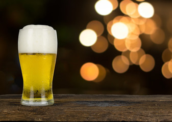 cold beer on the table wood and blur ligh background