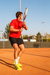 Professional tennis player man playing on court in afternoon. 