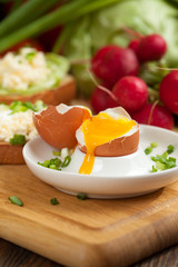 Boiled egg with crunchy bread and healthy vegetables for breakfast