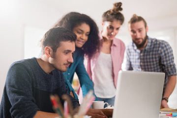 Young multiethnic creative team sharing ideas on a project 