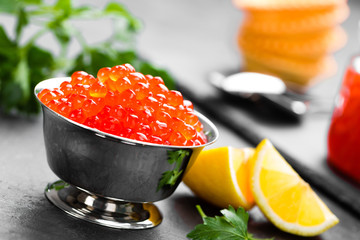Red salmon fish caviar, salmon caviar in metal bowl. Caviar. Selective focus