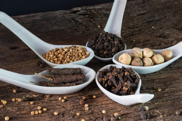 seasoning herbal in spoon on wood table for ingredient of food