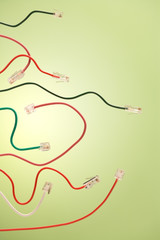 Computer net cables and telephone jack on a green background