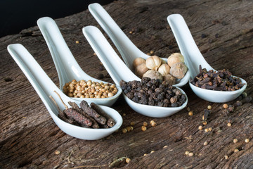 seasoning herbal in spoon on wood table for ingredient of food