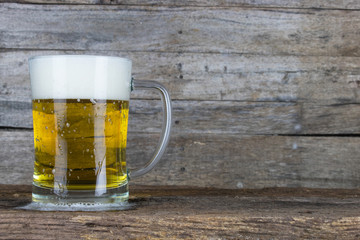 cold beer on the table wood background