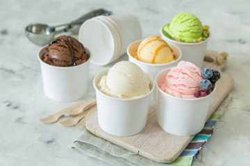Selection of colorful ice cream scoops in paper cones