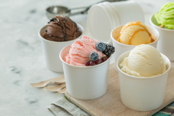 Selection of colorful ice cream scoops in paper cones
