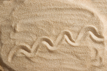 The sea and the waves are painted in the sand. Beach background. Top view. The concept of summer, summer kanikkuly, vacation, holydays.