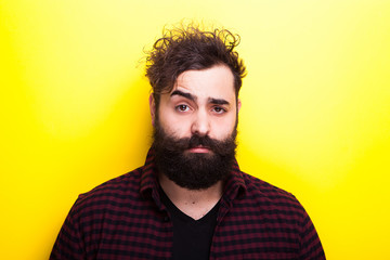 Obraz premium Portrait of man with long beard on yellow background in studio photo