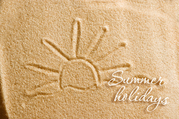 The heart is painted in the sand and the inscription is summer holidays. Beach background. View from above. The concept of summer, summer kanikkuly, vacation, holydays.