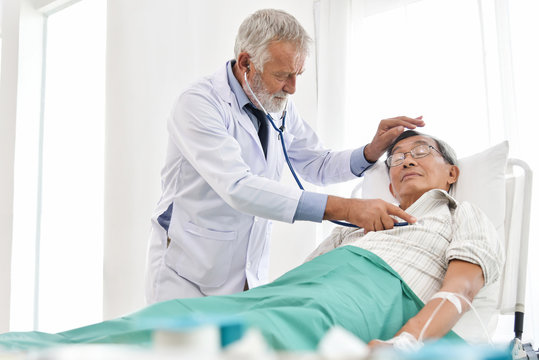 Doctor is examining An Asian senior patient.