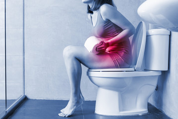 woman feel pain with constipation - obrazy, fototapety, plakaty