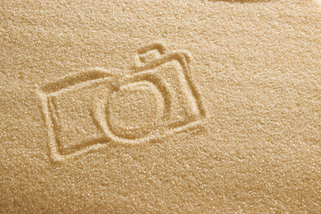 the camera is painted on the sand and the inscription is summer holidays. Beach background. View from above. The concept of summer, summer kanikkuly, vacation, holydays.