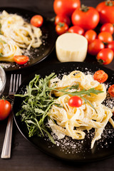 Plate with healthy and delicious italian pasta on wooden background