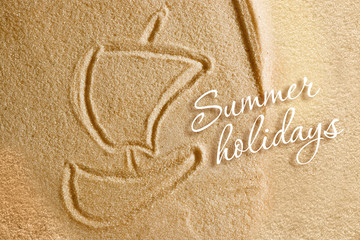 The boat with a sail is painted on the sand and the inscription is a summer holiday. Beach background. View from above. The concept of summer, summer kanikkuly, vacation, holydays.