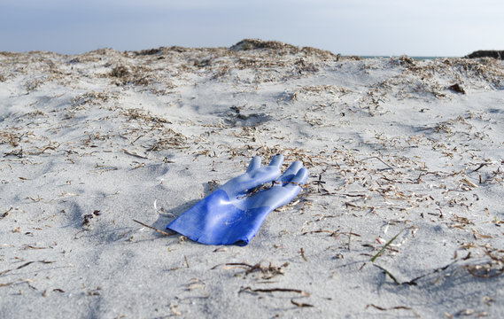 Laesoe / Denmark: A lost blue rubber glove lying in the dunes at Bloeden Hale