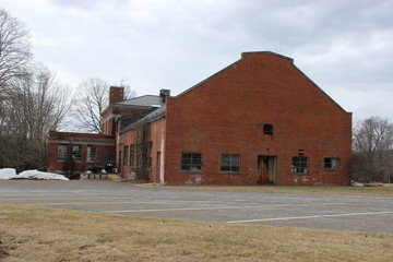 Abandoned and boarded up brick asylum building
