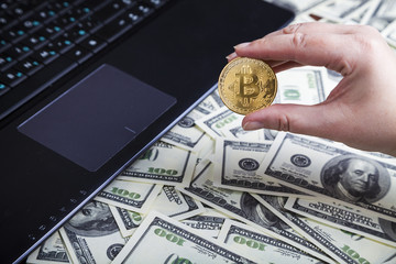 Female hand holds bitcoin