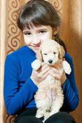 girl with a beige puppy