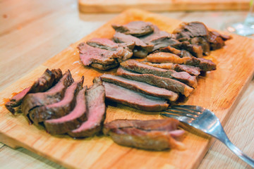 Close up sliced steak on cutting board