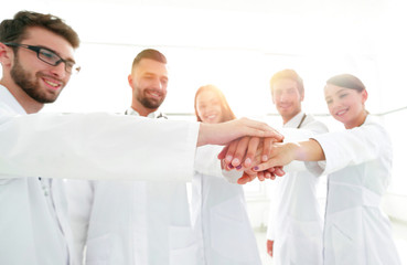 Fototapeta na wymiar Doctors and nurses in a medical team stacking hands