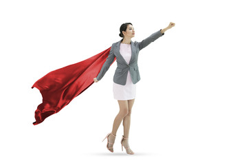 Young confident business superhero woman wearing red cape against isolated on white background....