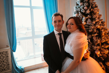 young bride and groom couple in a bright studio photo