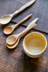Empty wooden bowls and spoons on wooden background