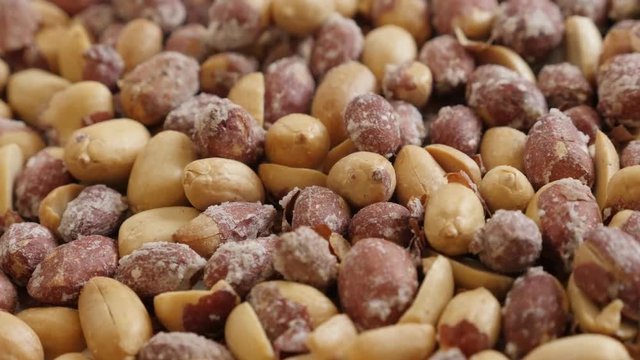 Close-up of Arachis hypogaea snack on pile footage - Popular salted and roasted groundnuts slow tilt 
