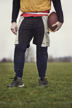 Close up view from the waist down of a male who is playing non-contact flag football.