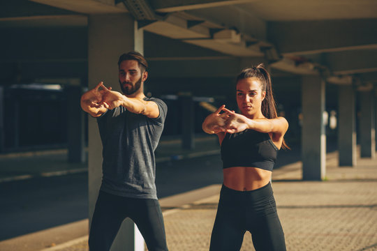 Young sports couple exercising in the urban environment