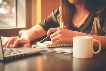 Young woman sit working in a coffee shop,Employees are working outside the company,Students are searching for reports at the restaurant,The girl is shopping online.