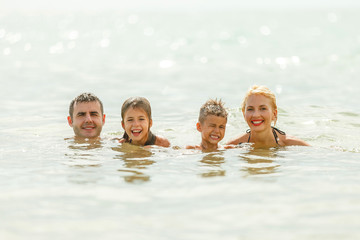 Fototapeta premium beautiful happy family swimming in sea together