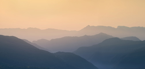 Fototapeta premium Landscape silhouette of the mountains at sunset. Panorama of peaks mountain in the Greece