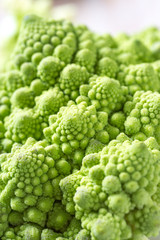 Closeup of romanesco broccoli or Roman cauliflower on wooden table