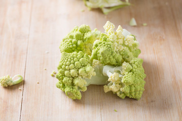 Romanesco broccoli or Roman cauliflower on wooden table, close up