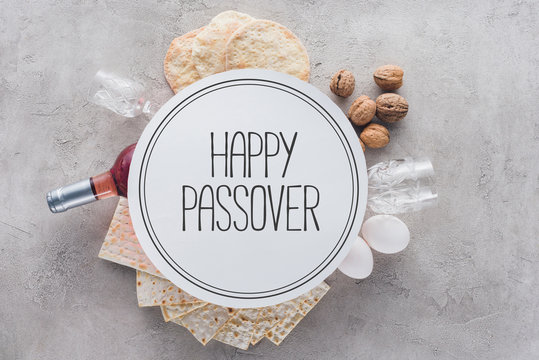 top view of matza and plate with happy passover greeting, jewish Passover holiday concept
