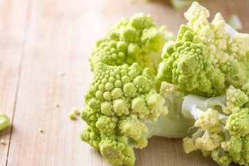 Romanesco broccoli or Roman cauliflower on wooden table, close up