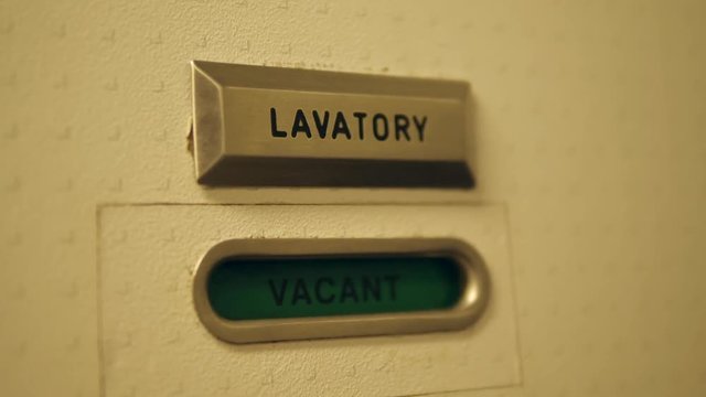 Airplane Lavatory Sign. Vacant and Occupied Message on Toilet Door. 4K.