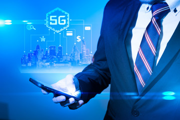 The abstract image of businessman using a smartphone overlay with 5g and cityscape hologram. the concept of 5G, communication, network, connection, internet of things.