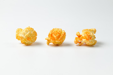 Three pieces of delicious popcorn on the white background