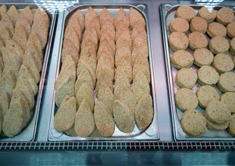 Semi-finished meat and fish cutlets on the shop window.