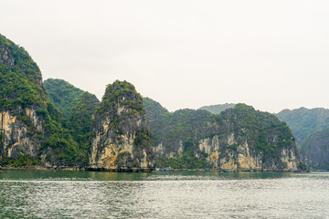 Fototapeta na wymiar Limestone cliff formations in Halong Bay, Vietnam