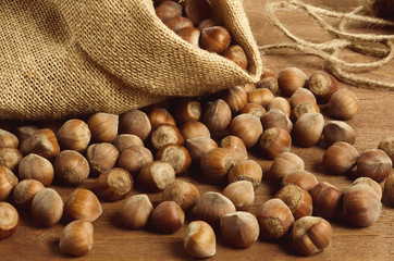 Hazelnuts in a yuta bag on wooden table